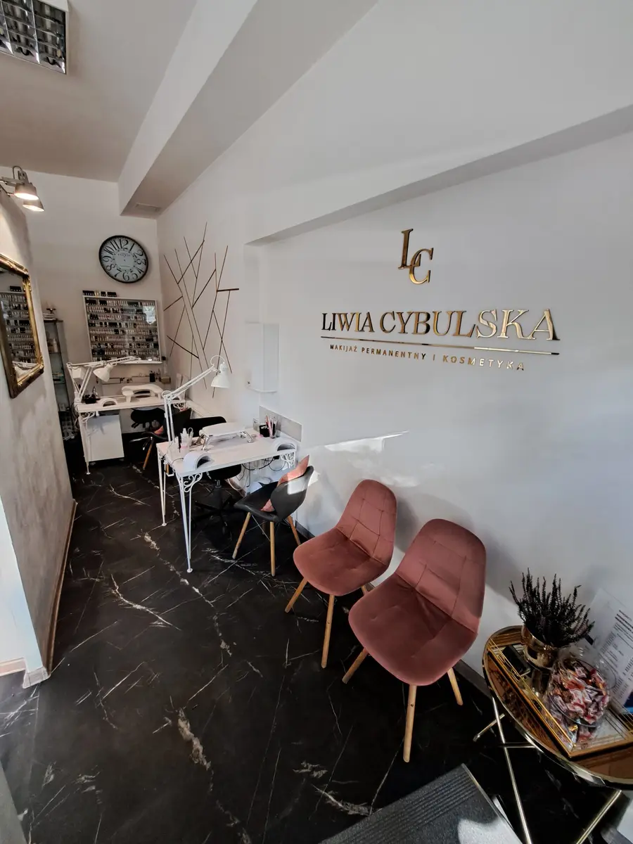 Recepcja gabinetu ze złotym logo Liwia Cybulska na ścianie